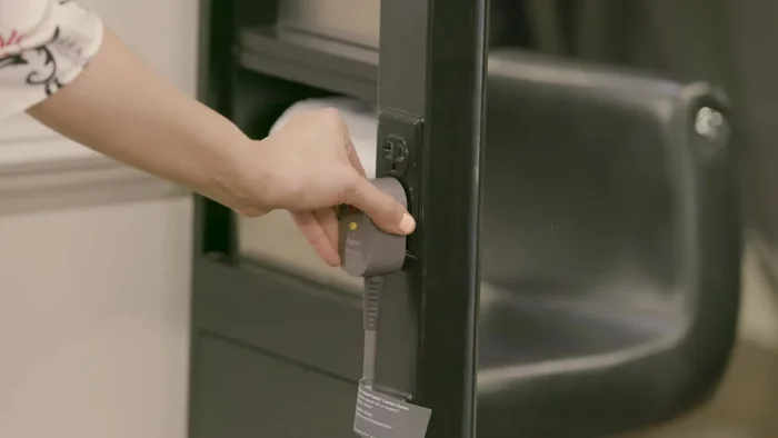 Gently pull open the cage and slide it off the cable.