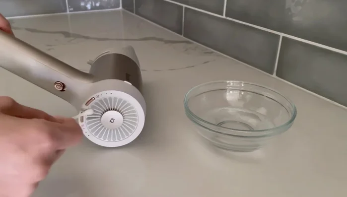 Scrub with soapy water: Dip a cotton swab in the soapy water and gently scrub each section of the mesh filter. Replace swabs as needed.