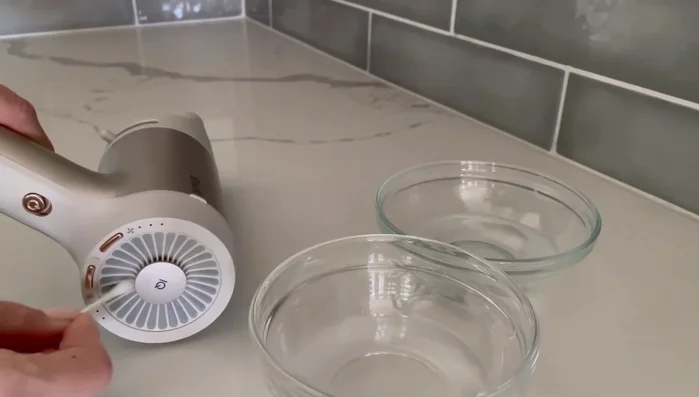 Rinse with pure water: Repeat the scrubbing process using pure water and fresh cotton swabs to remove soap residue.