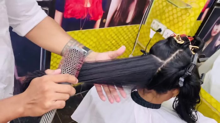 Sectioning: Divide hair into sections (top, middle, sides) using clips.