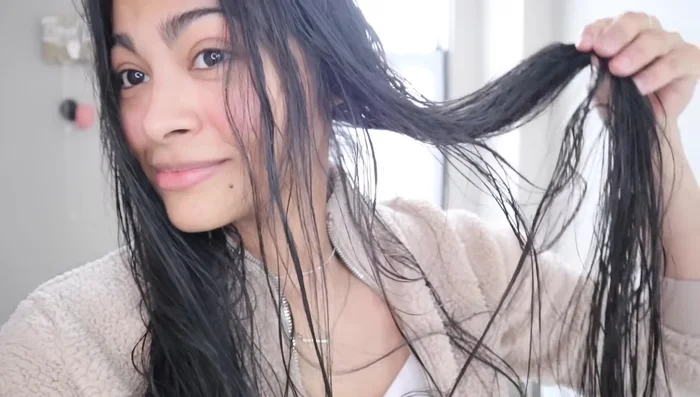 Apply a hydrating product (leave-in conditioner or hair serum) to damp hair (40-80% dry depending on hair type).