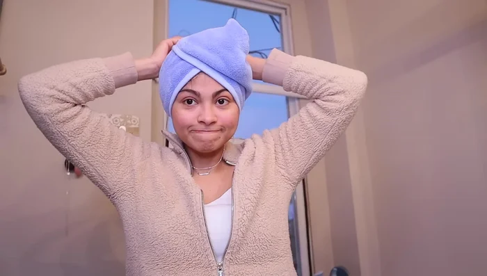 Cover your hair with a microfiber towel, t-shirt, silk cap, or scarf to protect it and prevent frizz while it air dries. Avoid touching your hair.