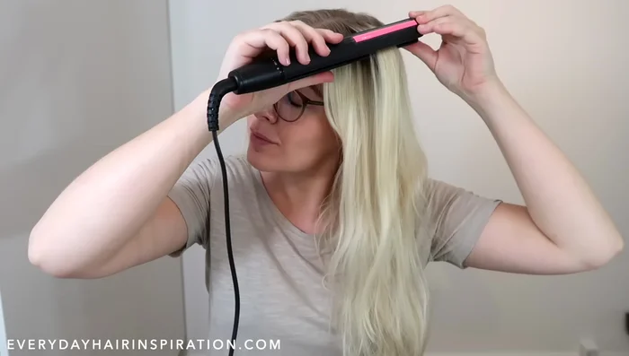 Slowly glide the straightener down the hair while holding it horizontally. Once you reach the end, gently grab the curl and twist it.
