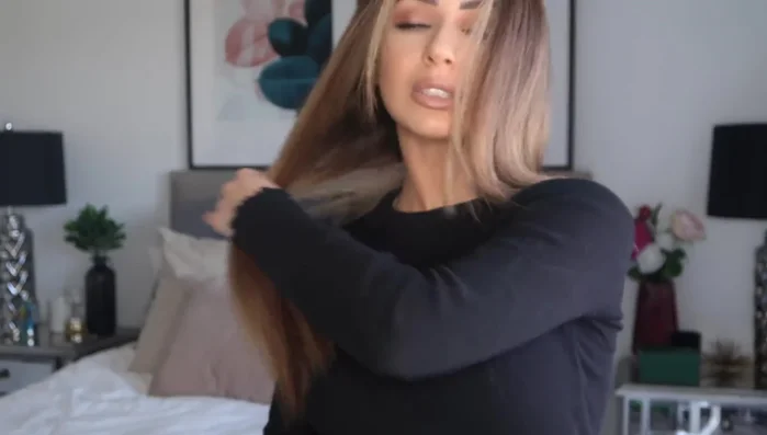 Straighten hair using a curling iron, clamping sections of hair and gently gliding the curling iron from root to tip, flipping the ends under to create volume and smoothness. Repeat for all sections.