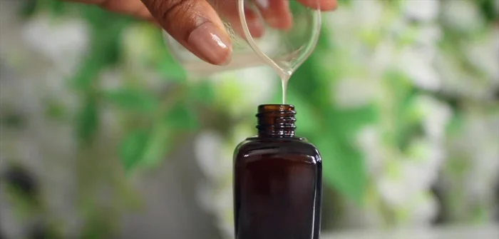 Shake the bottle before applying a tiny amount to the ends of your hair, working upwards and avoiding the scalp.