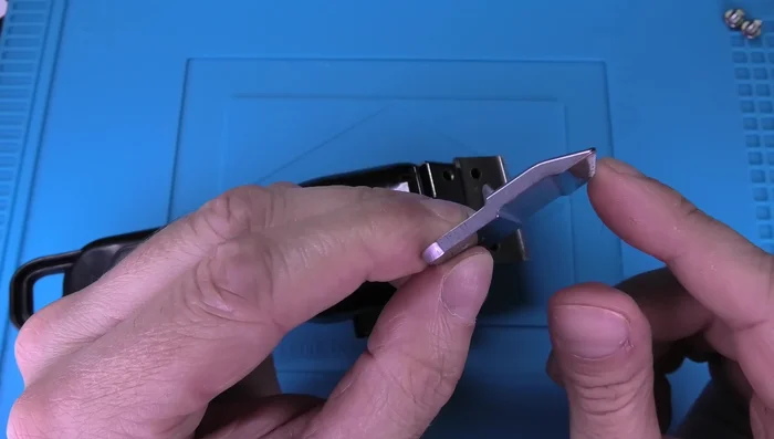 Install the bottom blade (lined side away from the machine, grooved side towards the machine).