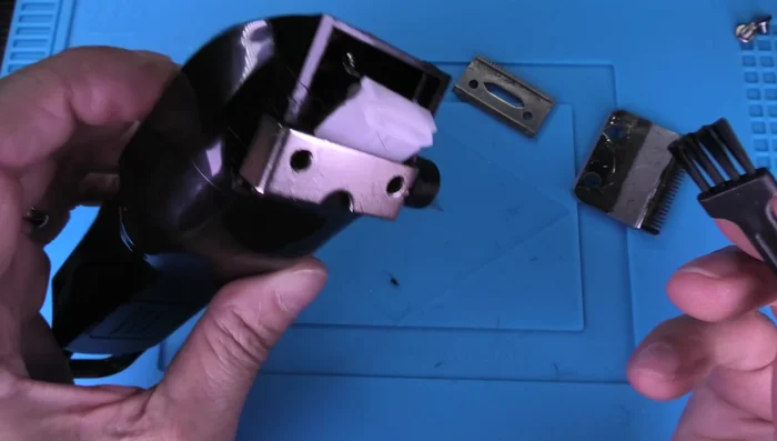 Clean the inside of the clipper using the small brush to remove any trapped hair or dirt.