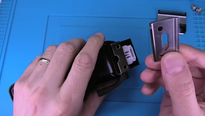 Install the bottom blade (lined side away from the machine, grooved side towards the machine).