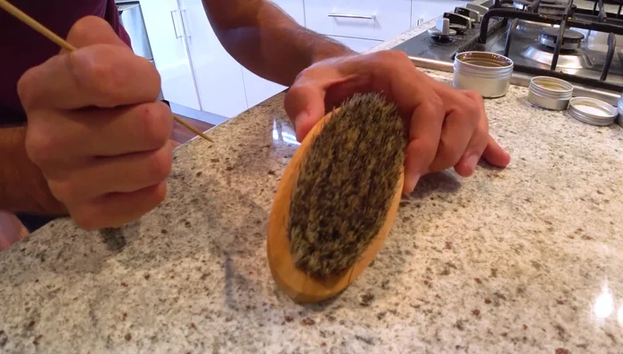 Scrape out hair and wax: Use a knitting needle, scissors, or other sharp tool to remove hair and solidified wax from the bristles.