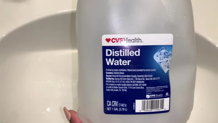 Set up the hair steamer using distilled water (crucial to avoid damage).