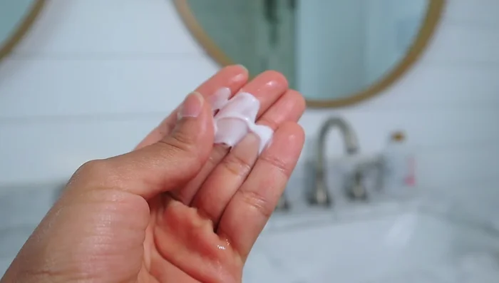 Apply heat protectant product evenly throughout hair, focusing on the ends to prevent split ends.