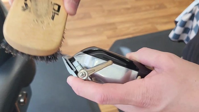 Remove all hair from the clippers using the cleaning brush.