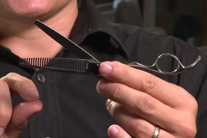 Use a 32-tooth thinning scissor to remove weight and blend hair sections seamlessly without visible cut marks.