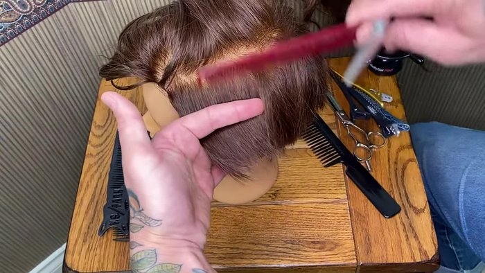 Comb and hold the hair.