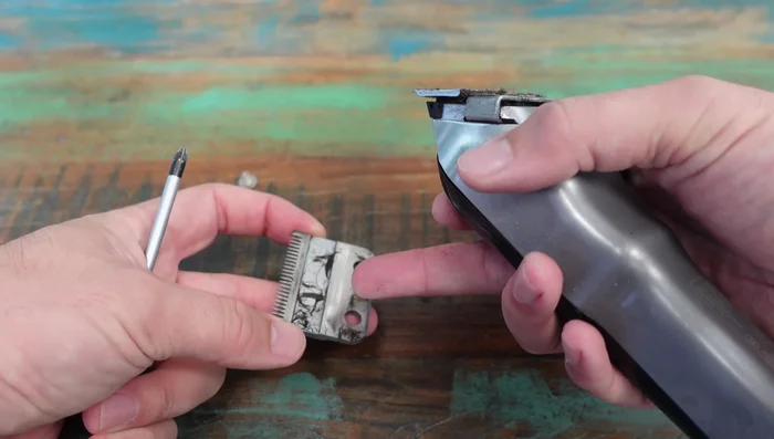 Remove the blade and clean away any remaining hair and debris using the brush, paying close attention to areas around the moving parts and the switch.