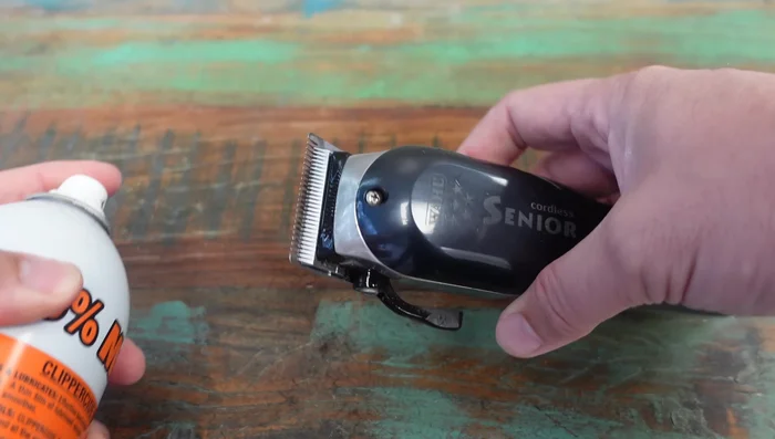 Submerge clippers in clipper side spray to remove built-up hair and gunk (repeat as necessary).