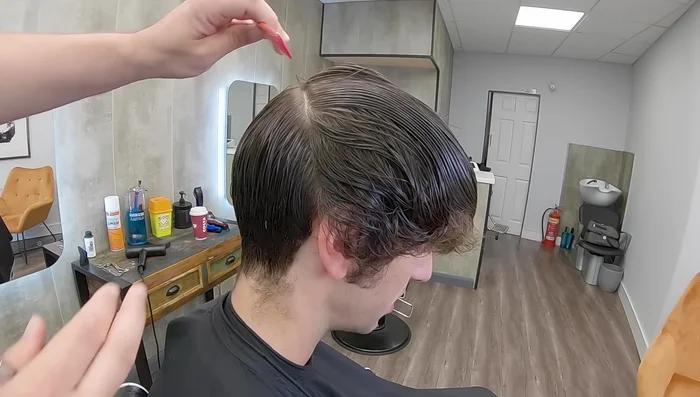 Use the previously cut shorter sections as guides to blend the longer top sections using the scissor-over-comb technique.