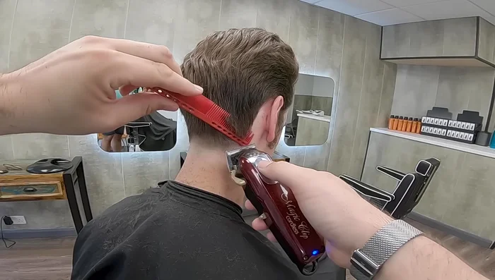 Use the clipper-over-comb technique to carefully remove weight around the ears and sides, avoiding over-tapering.