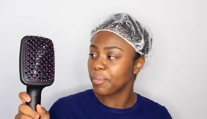 Woman using shower cap for hair styling