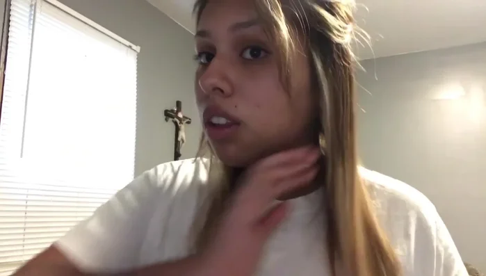 Woman shows straight, shiny hair after straightening.