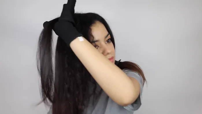 Woman straightening naturally curly hair.