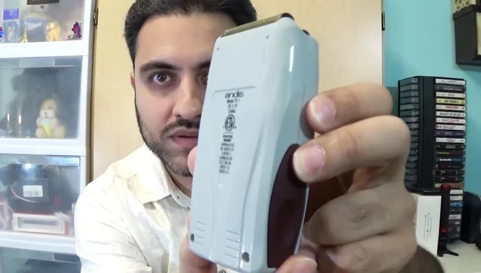 Compact Andis Profoil shaver in hand