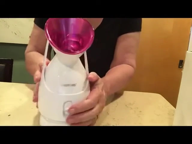 Person holding facial steamer