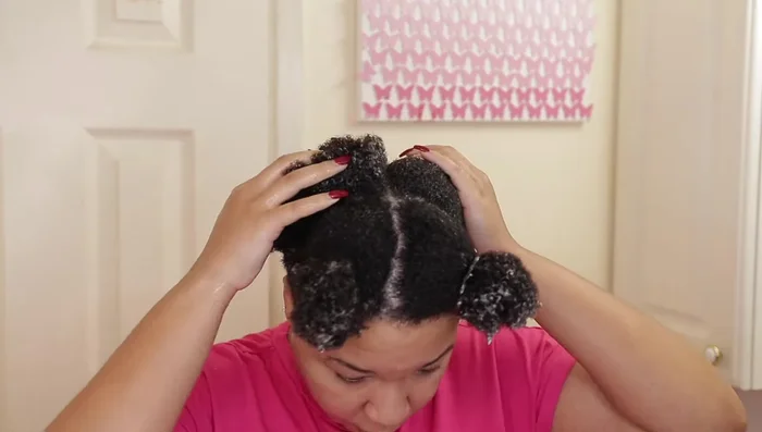 Woman applying curl gel to 4c hair