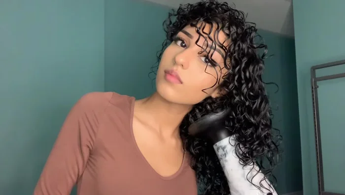 Flip your hair: Once half dry, flip your hair upside down and continue diffusing for maximum volume.