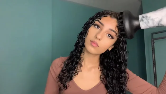 Diffuse the roots first: Focus on drying the roots to minimize frizz and add volume. Gently massage the roots while diffusing for extra volume.