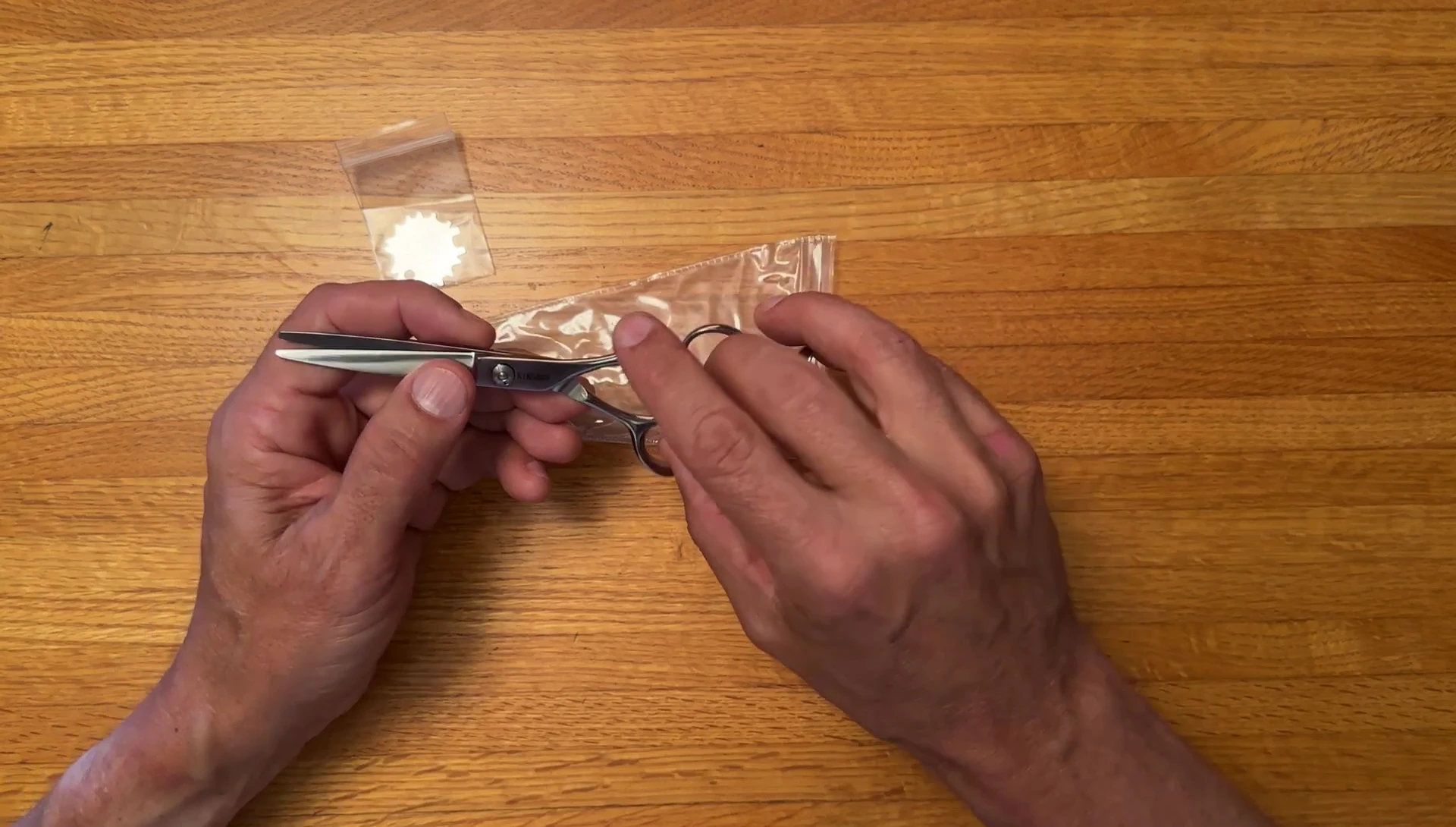 Person using sharp scissors for trimming.