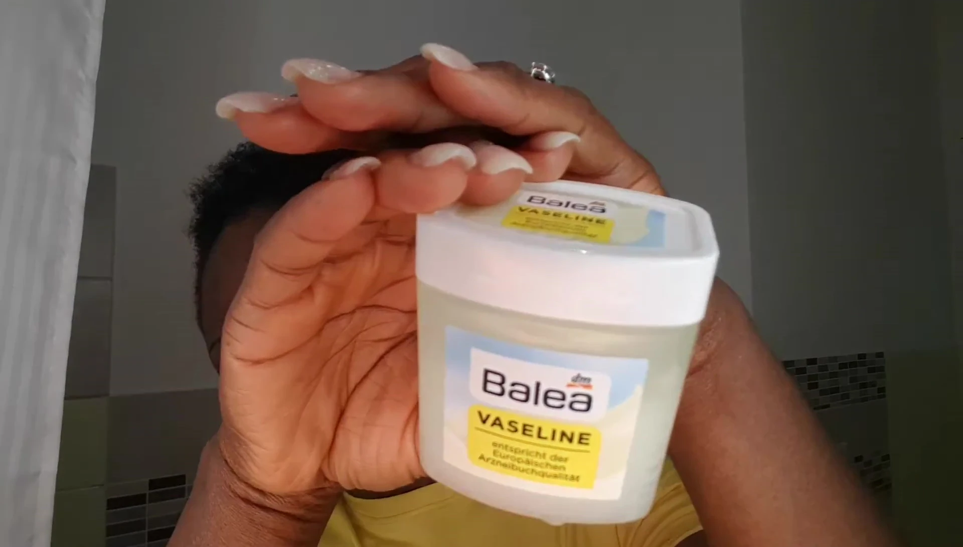 Applying Vaseline to protect the hairline.