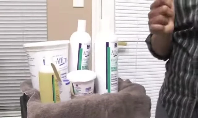 Hair being relaxed with Avalon Fiber Guard