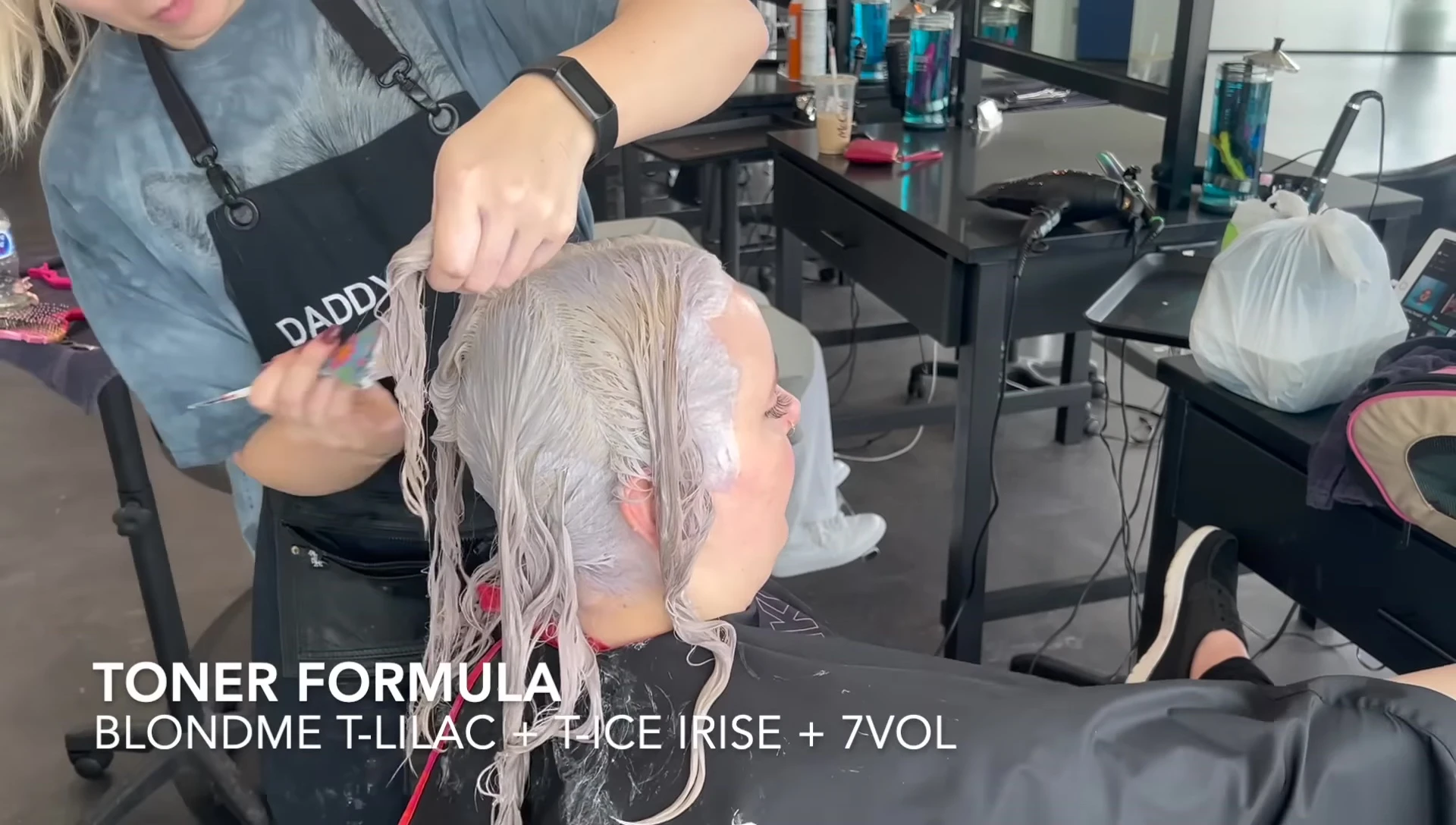 The stylist applying the toner.