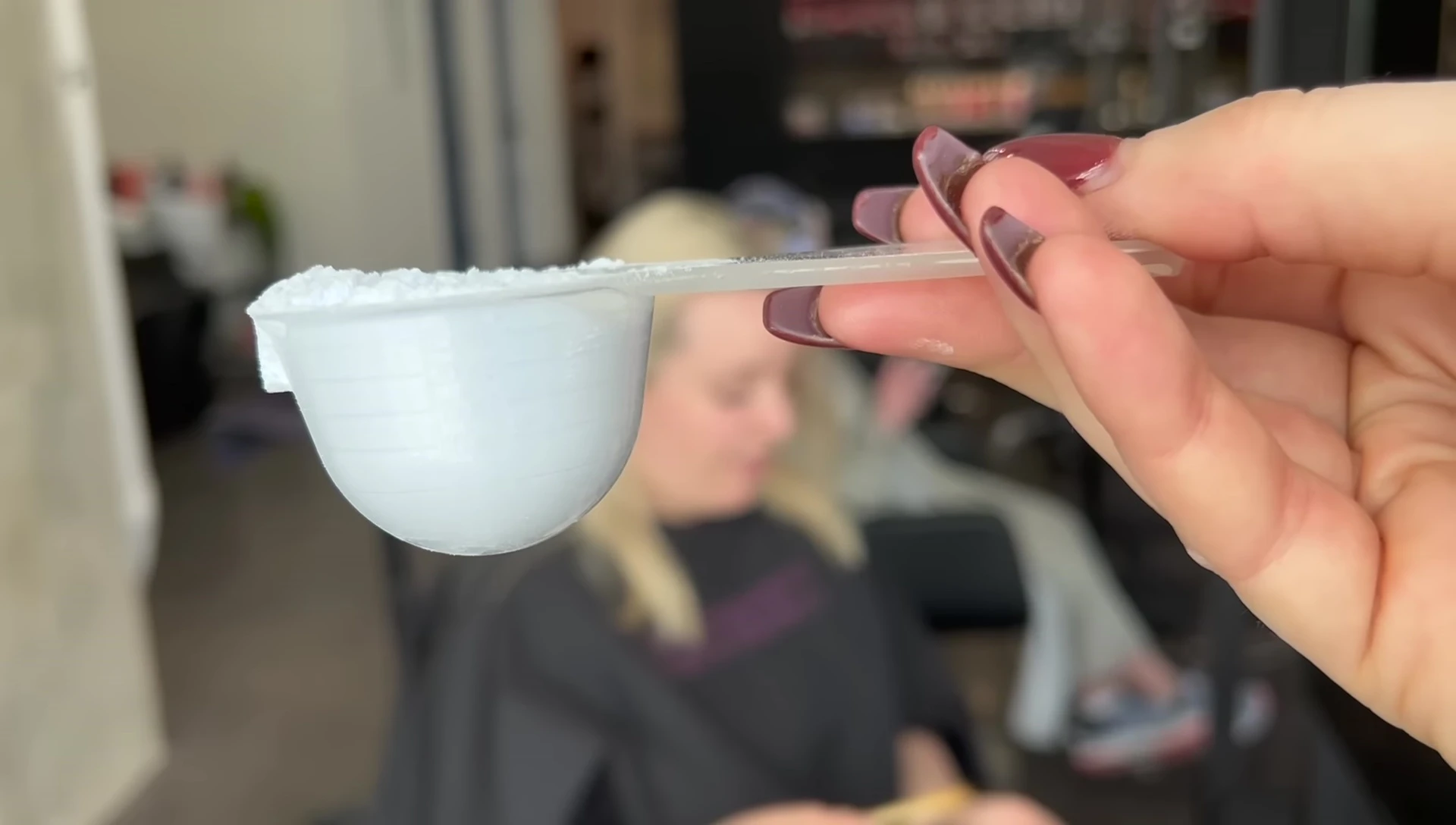 Stylist showing the amount of bleach being used.