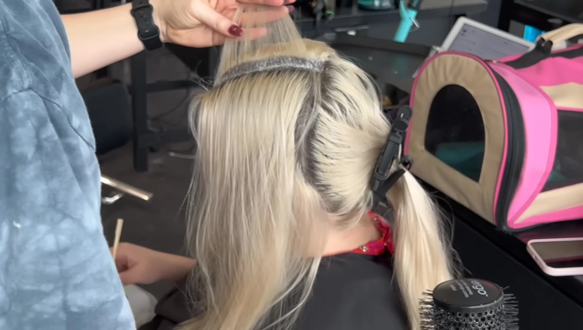 Stylist beginning to apply the Wella Blondor bleach.