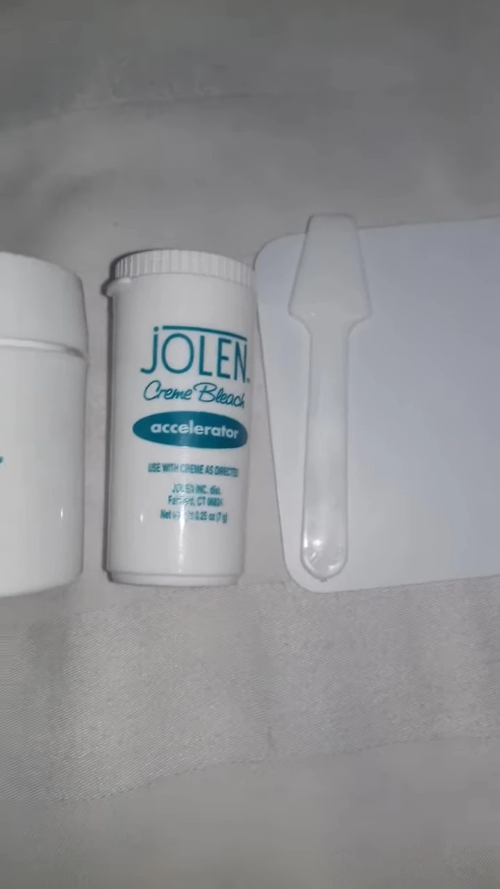 The reviewer holds up the Jolen Creme Bleach