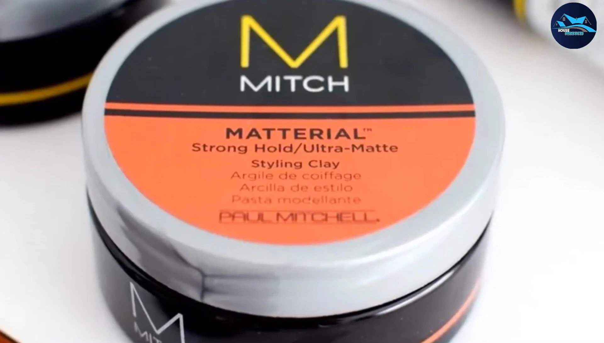 Someone applying Paul Mitchell Mitch Material Styling Clay