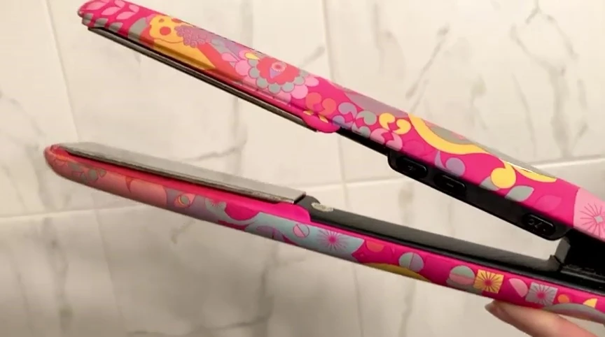 Person styling hair with the straightener