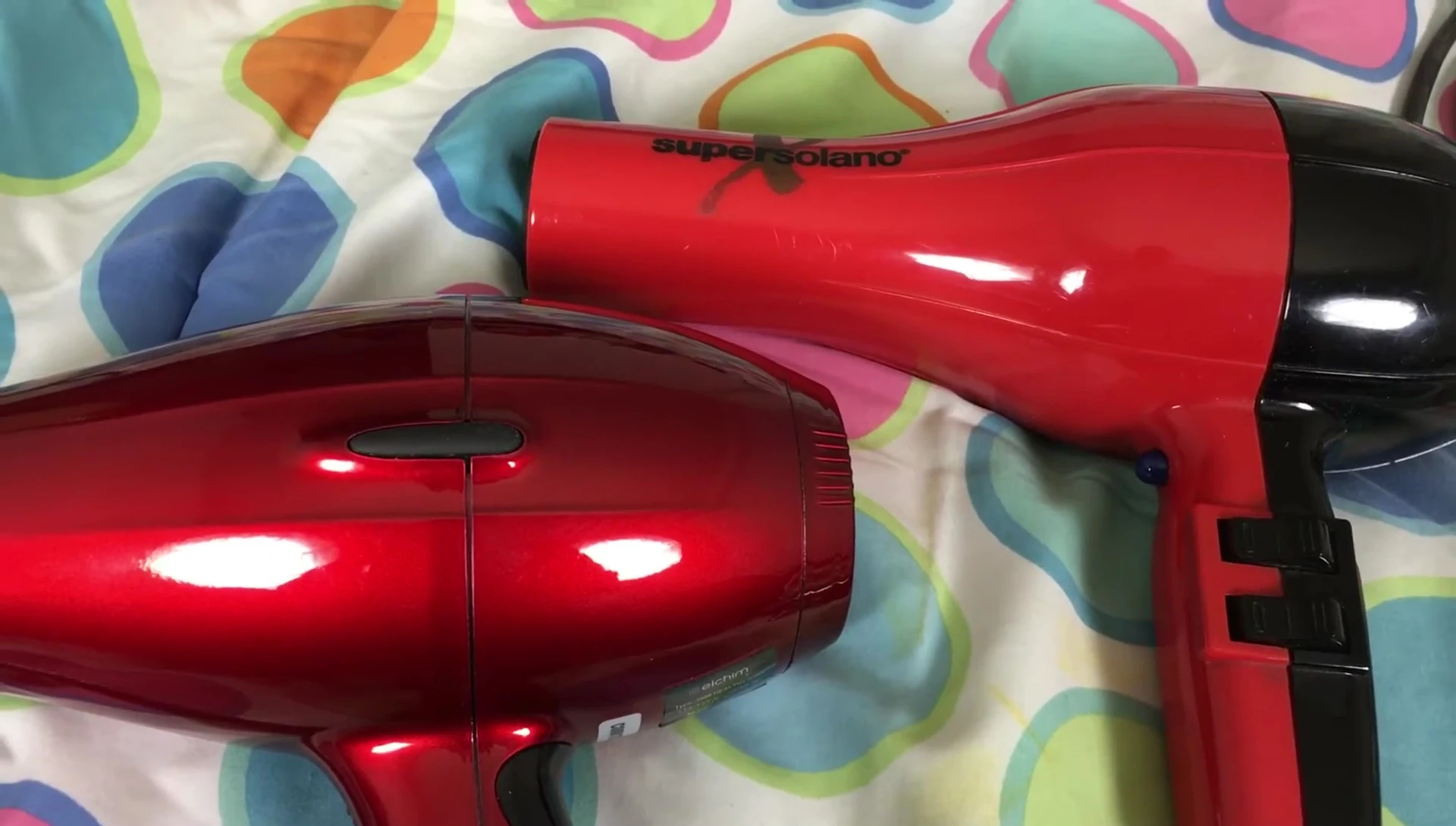 Close-up comparison of the paint finish on both hair dryers; Elchim's metallic finish vs. SuperSolano's plastic.