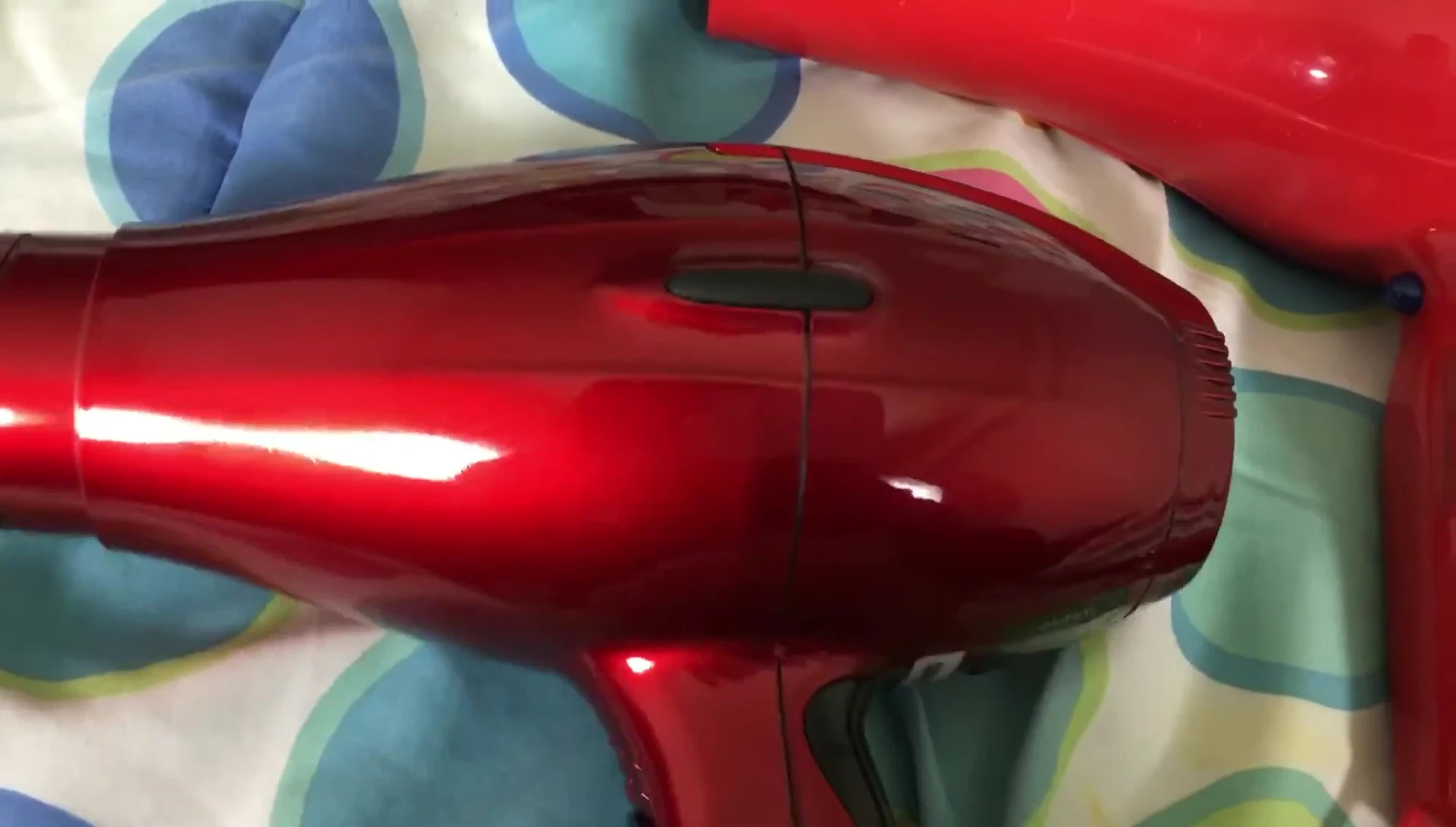 Visual comparison of the airflow from both hair dryers, emphasizing Elchim's superior power.