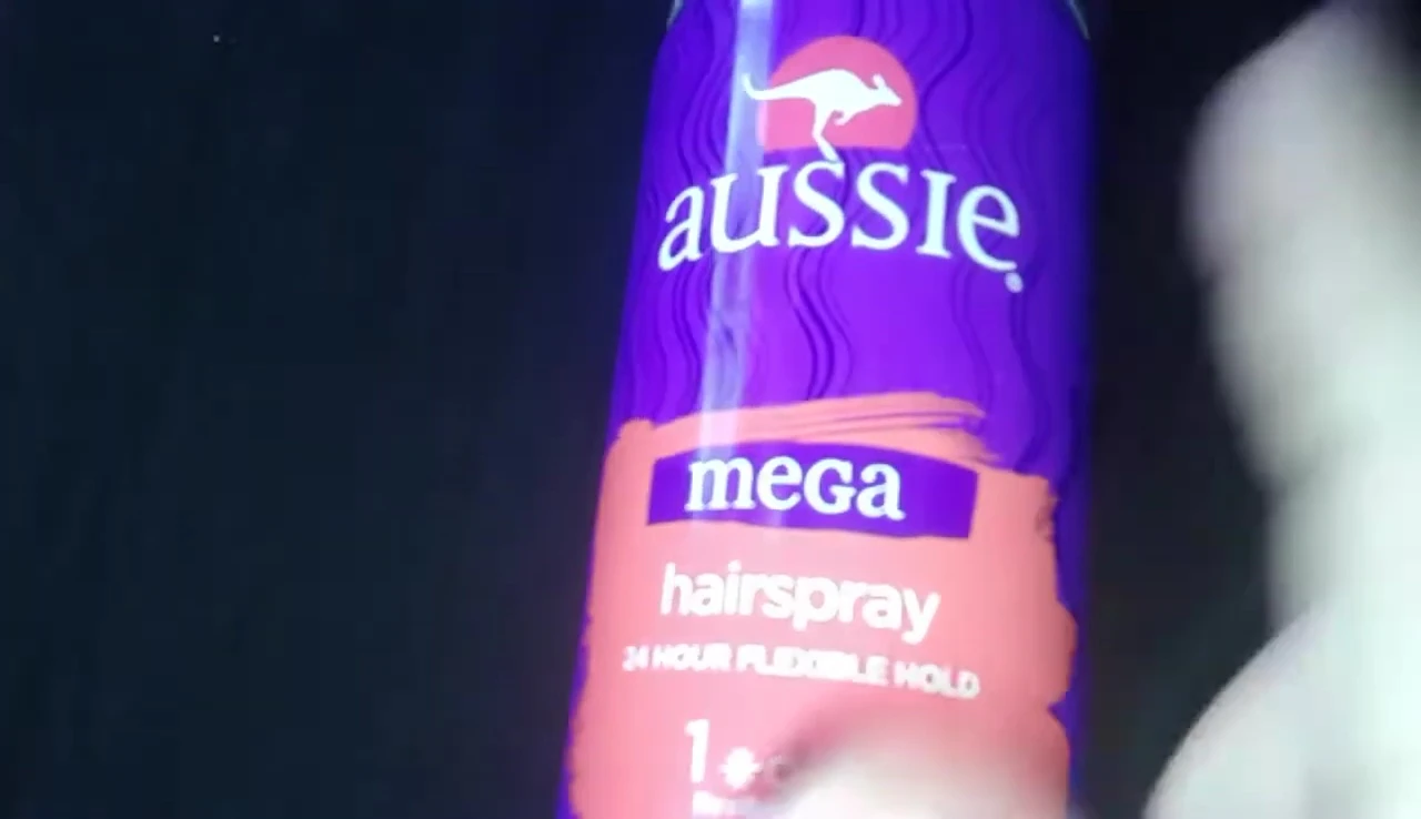 Close-up of the Aussie Mega Hairspray can, highlighting the brand name and size.