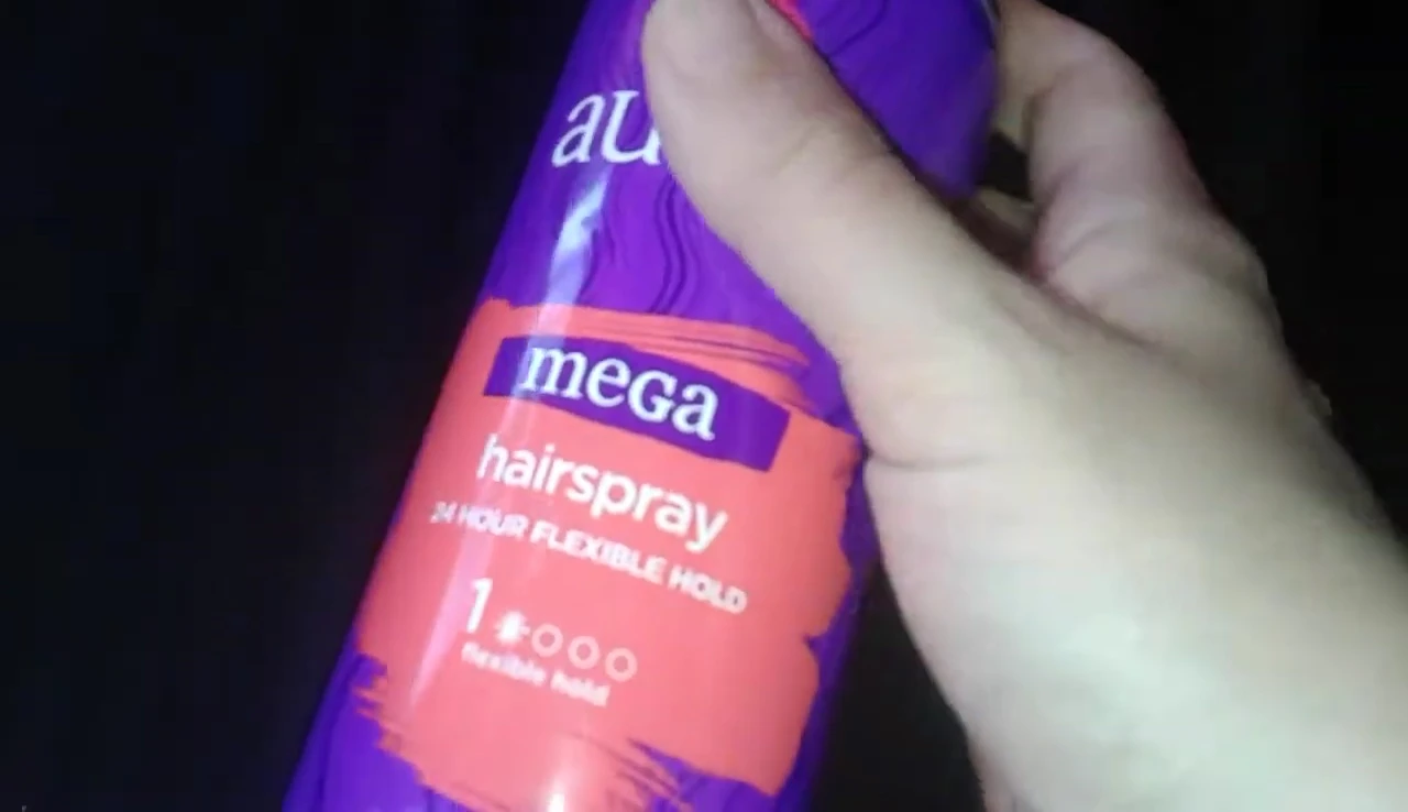 The reviewer demonstrating the strong hold of the hairspray.