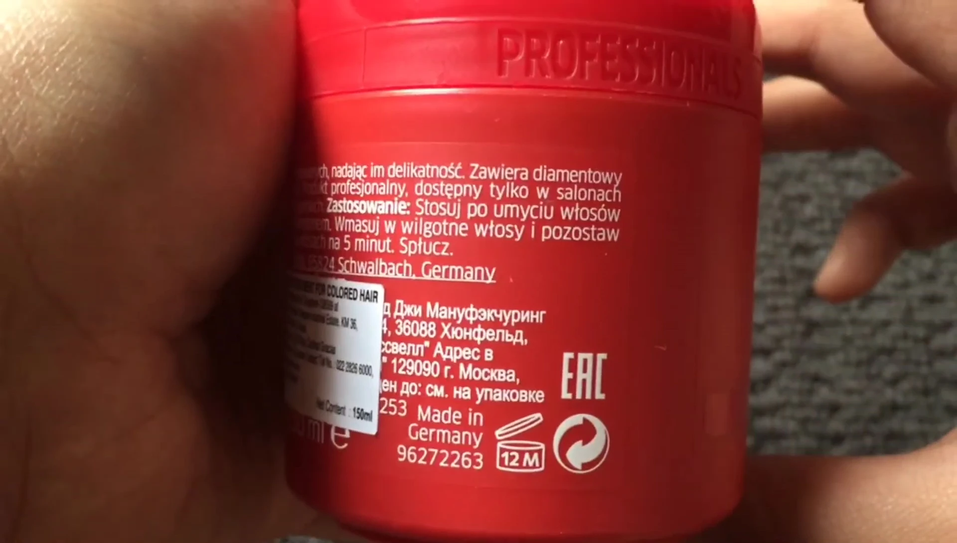 The speaker showing the hair mask tube, highlighting its appealing packaging.