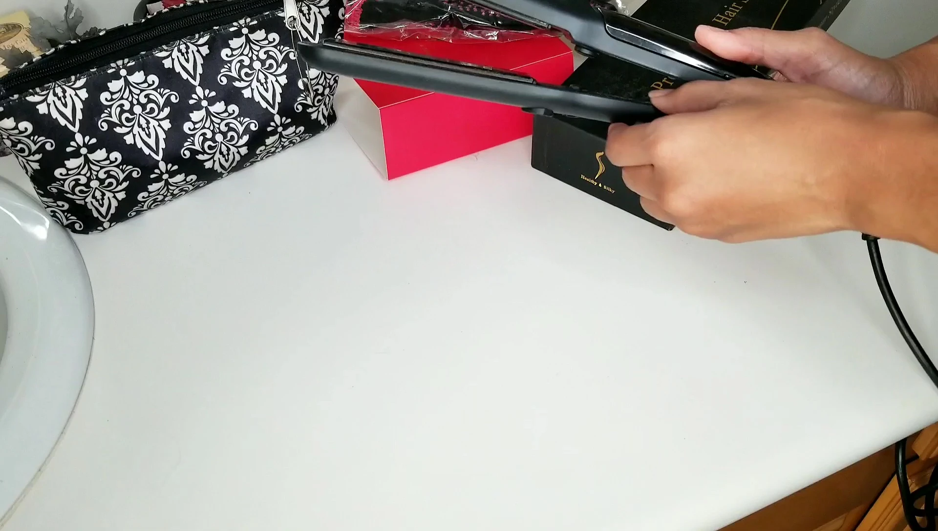 Turning on the flat iron and adjusting the temperature