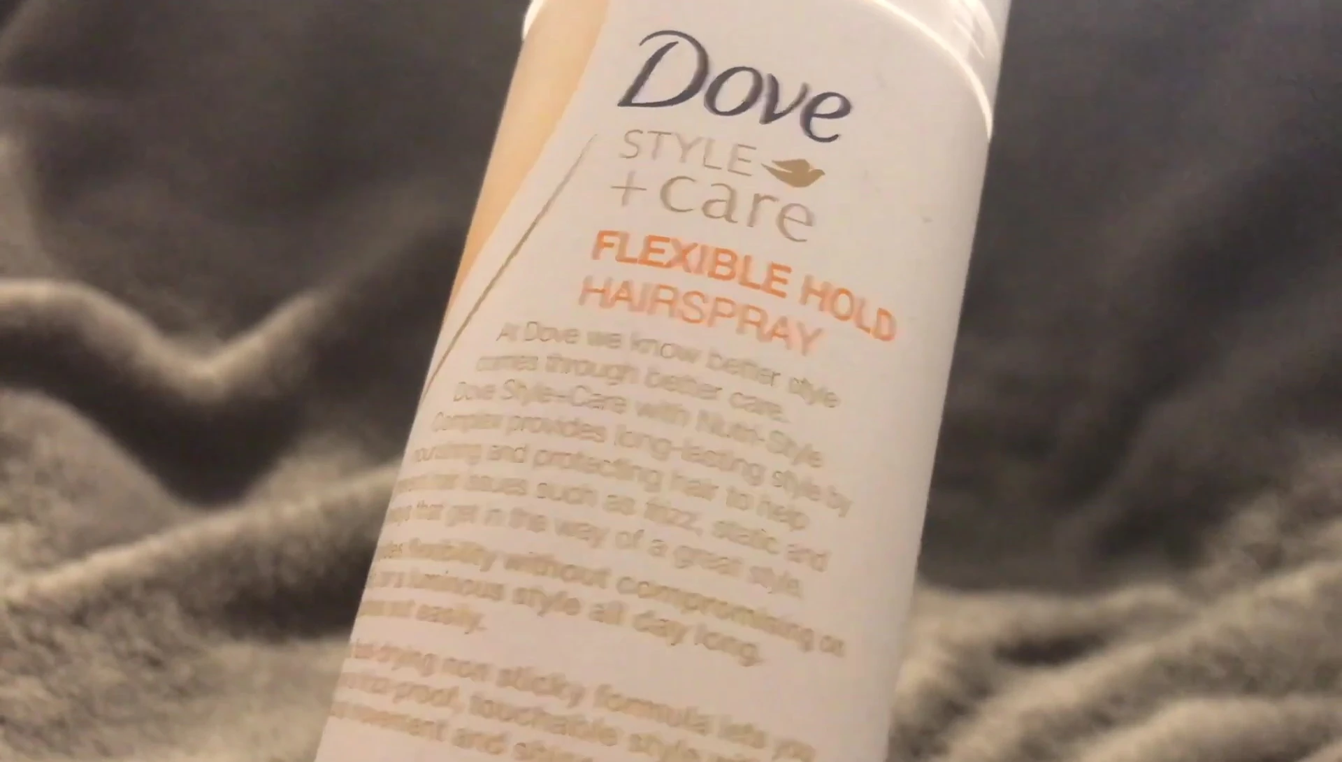 The reviewer demonstrating how easily the hairspray brushes out.