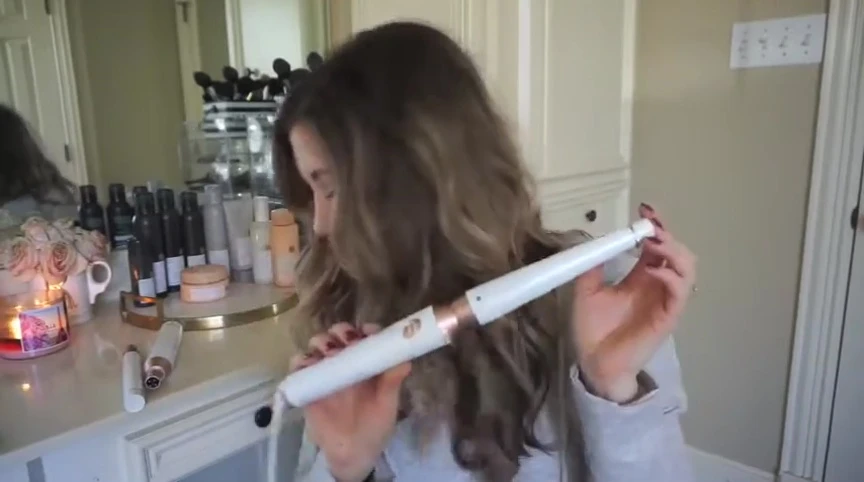 The speaker showing the T3 curling wand.