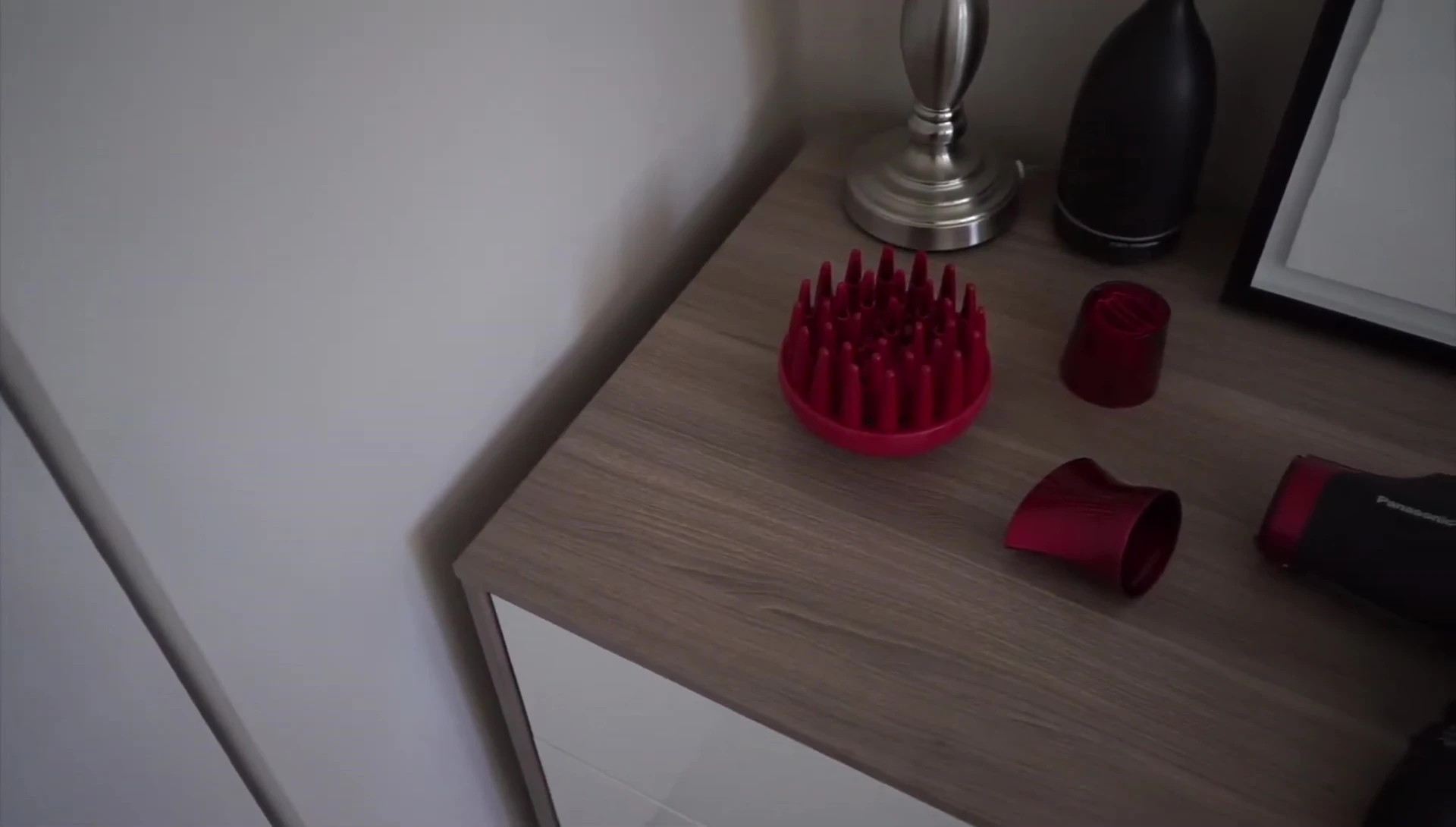 The reviewer holding the hair dryer