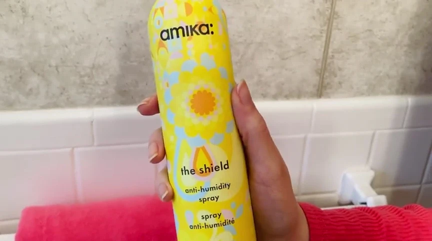 The spray bottle with the label visible showing the ingredient list.