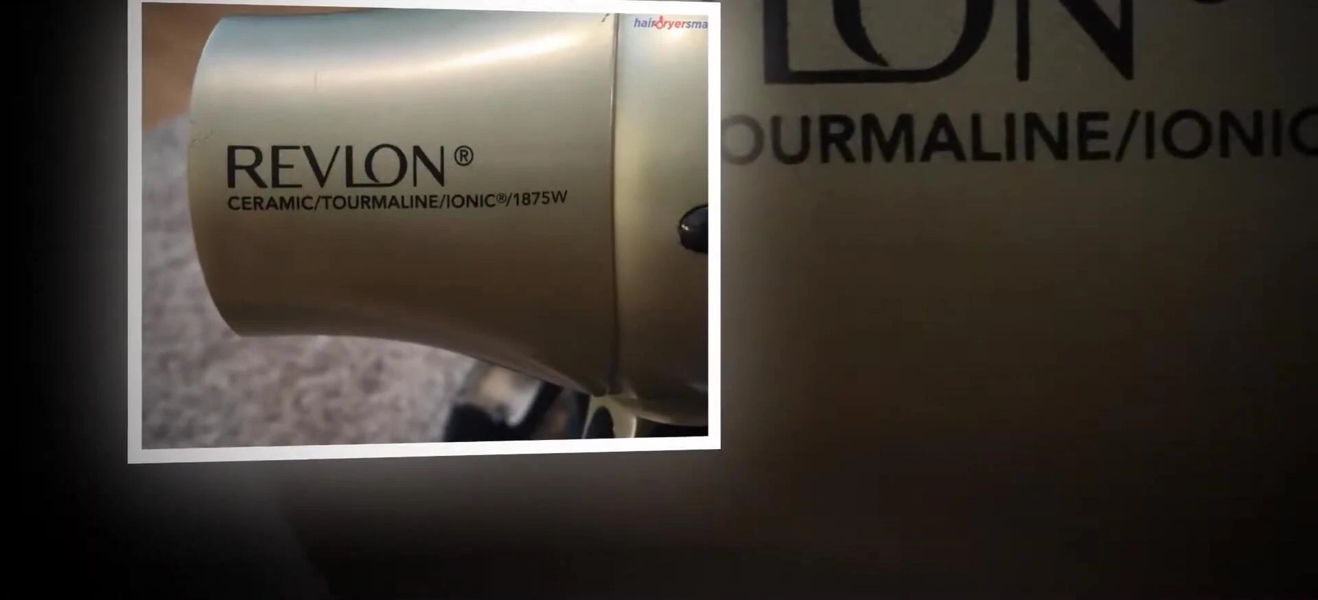 The hair dryer with its folding handle demonstrated.